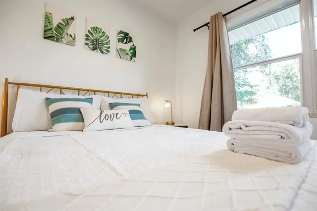 a bedroom with a bed and a window