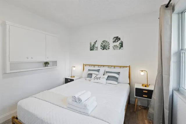 a bedroom with a bed and a table