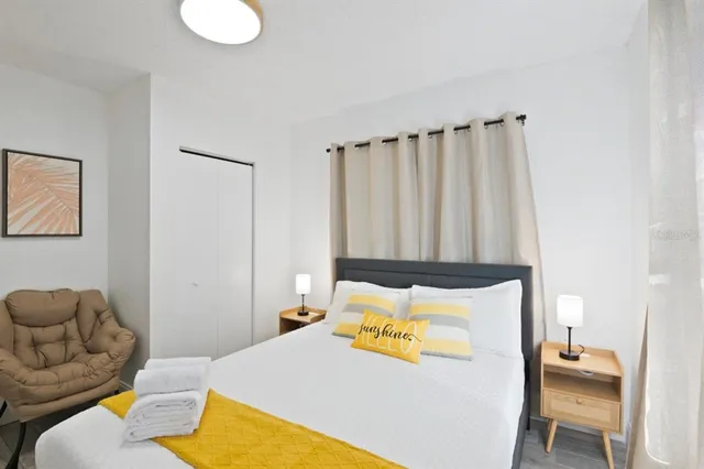 a bedroom with a bed and a chair