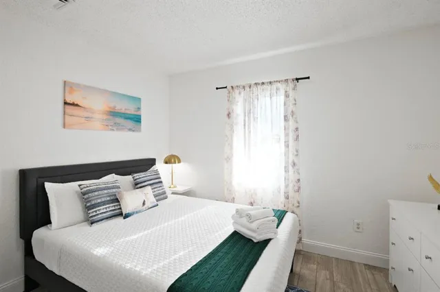 a bedroom with a bed and a window