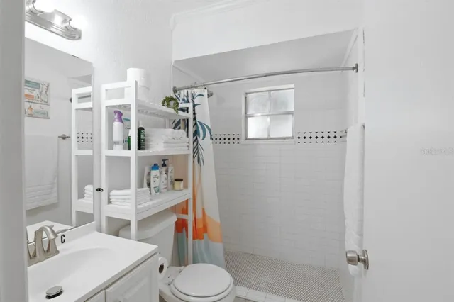 a bathroom with a sink toilet and shower