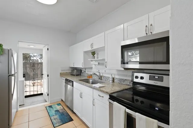 a kitchen with a sink stove and cabinets