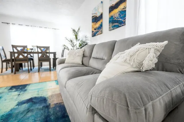 a living room with furniture and a large window