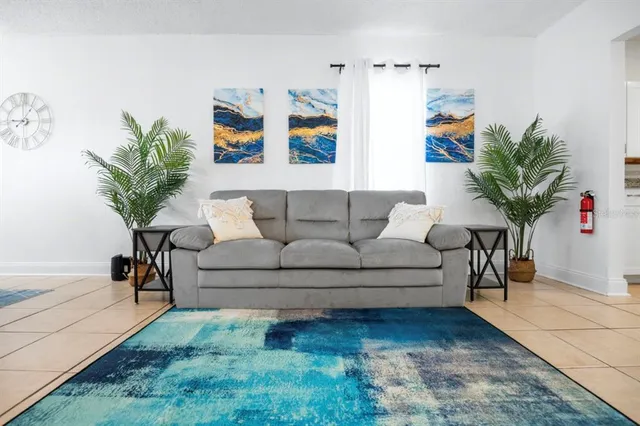 a living room with furniture and a potted plant