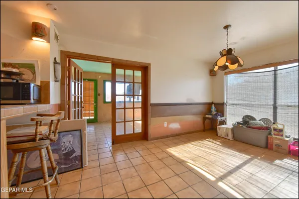 a view of a hallway with dining area