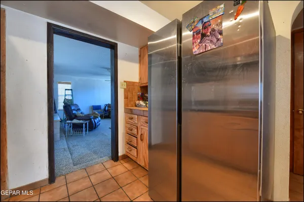 a bedroom with a bed a chandelier and a dresser