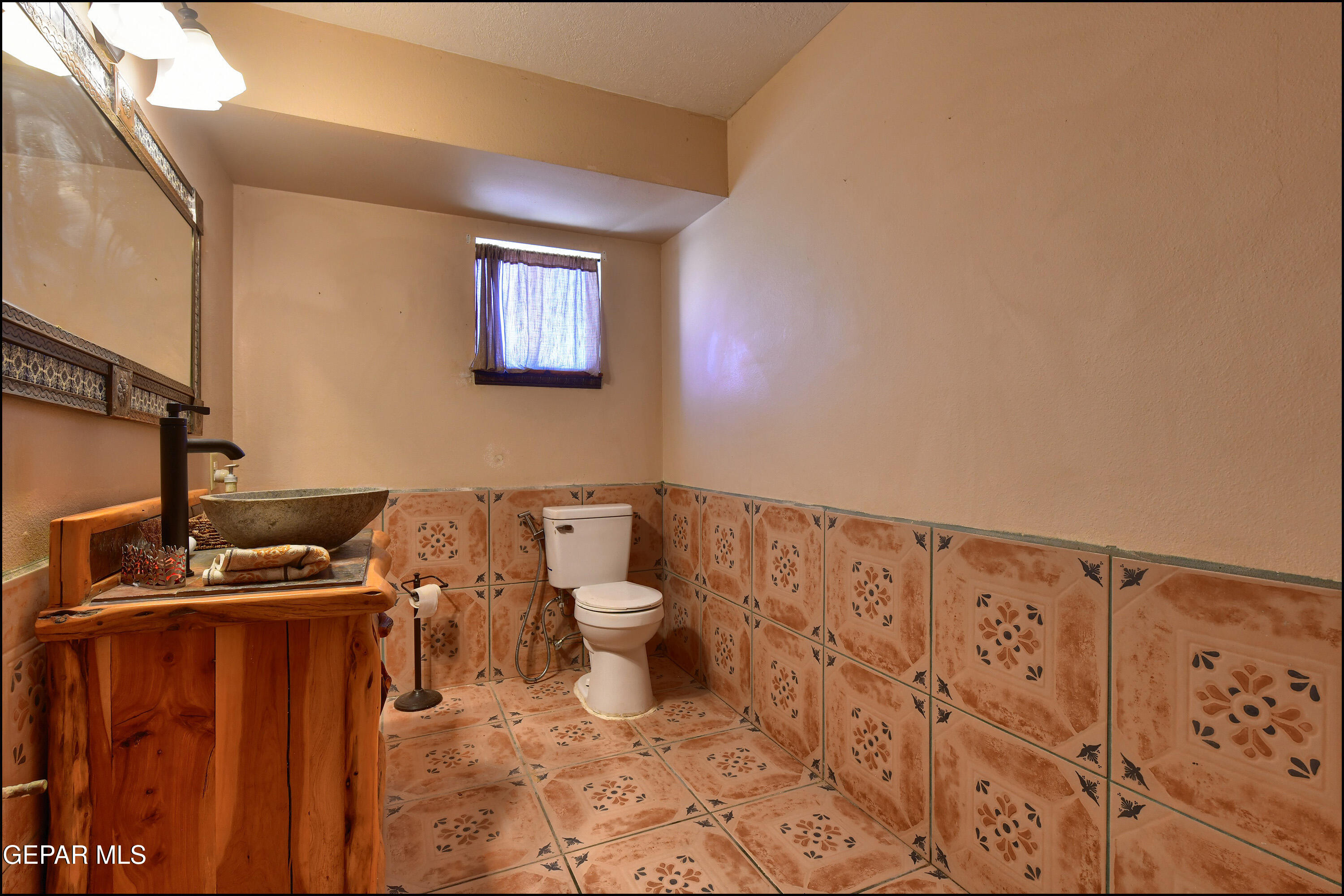 395 Gabaldon Road Anthony, NM 88021 - Photo 26 of 84 a bathroom with a toilet a sink and a shower curtain