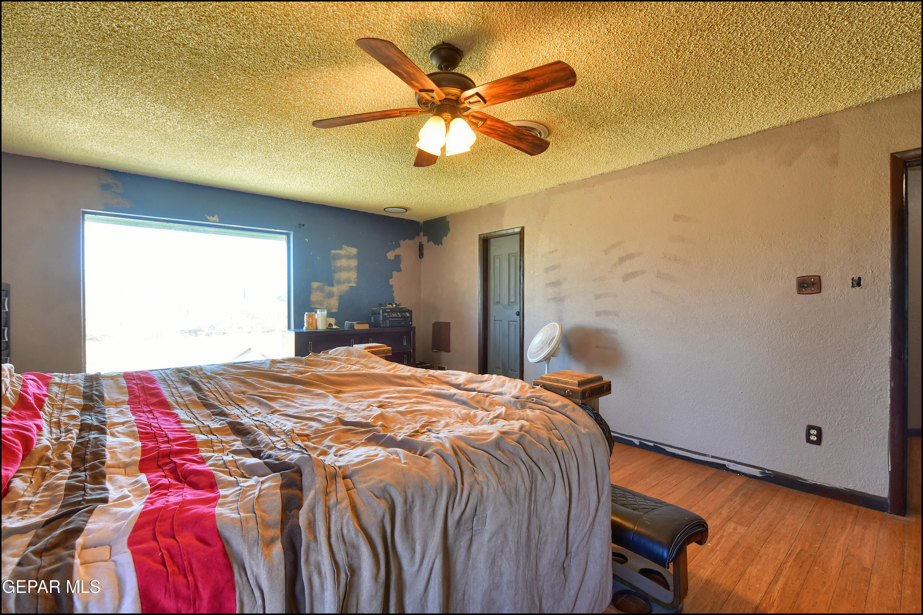 395 Gabaldon Road Anthony, NM 88021 - Photo 31 of 84 a bedroom with a bed and a ceiling fan