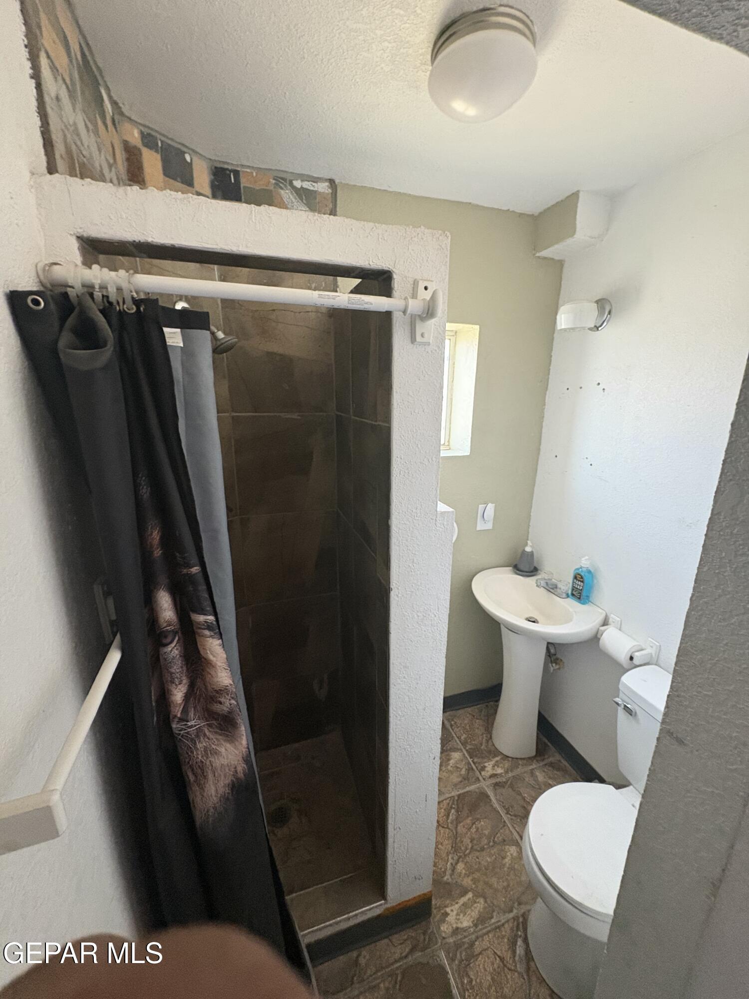 395 Gabaldon Road Anthony, NM 88021 - Photo 56 of 84 a white toilet sitting next to a bathroom sink