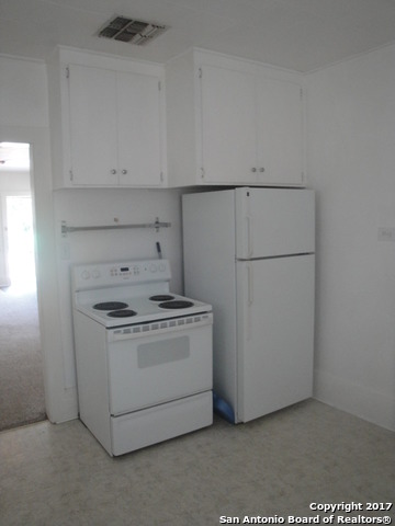 615 East Elm Street Seguin, TX 78155 - Photo 15 of 23 a kitchen with a stove and a refrigerator