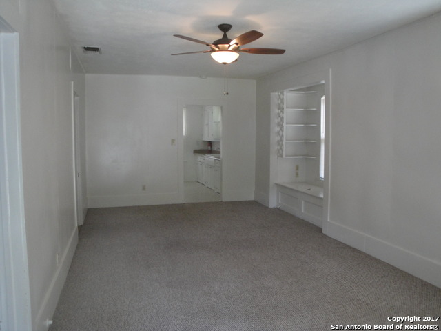 615 East Elm Street Seguin, TX 78155 - Photo 5 of 23 an empty room with a ceiling fan and a window