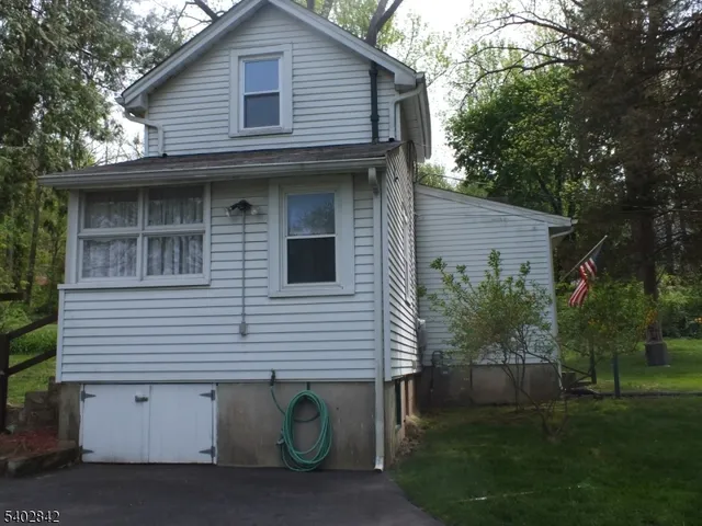 a view of house with backyard