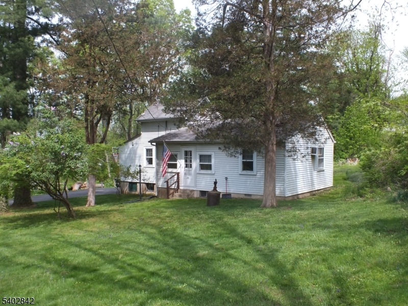 29 Ideal Street Gillette, NJ 07933 - Photo 16 of 25 a front view of a house with a garden and trees