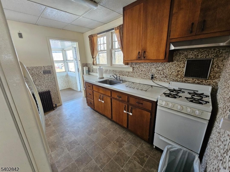29 Ideal Street Gillette, NJ 07933 - Photo 5 of 25 a kitchen with a stove a sink and a refrigerator
