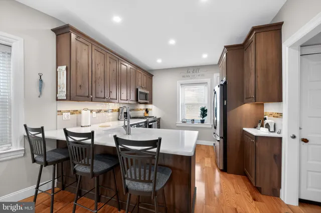 a view of kitchen with granite countertop cabinets table and chairs