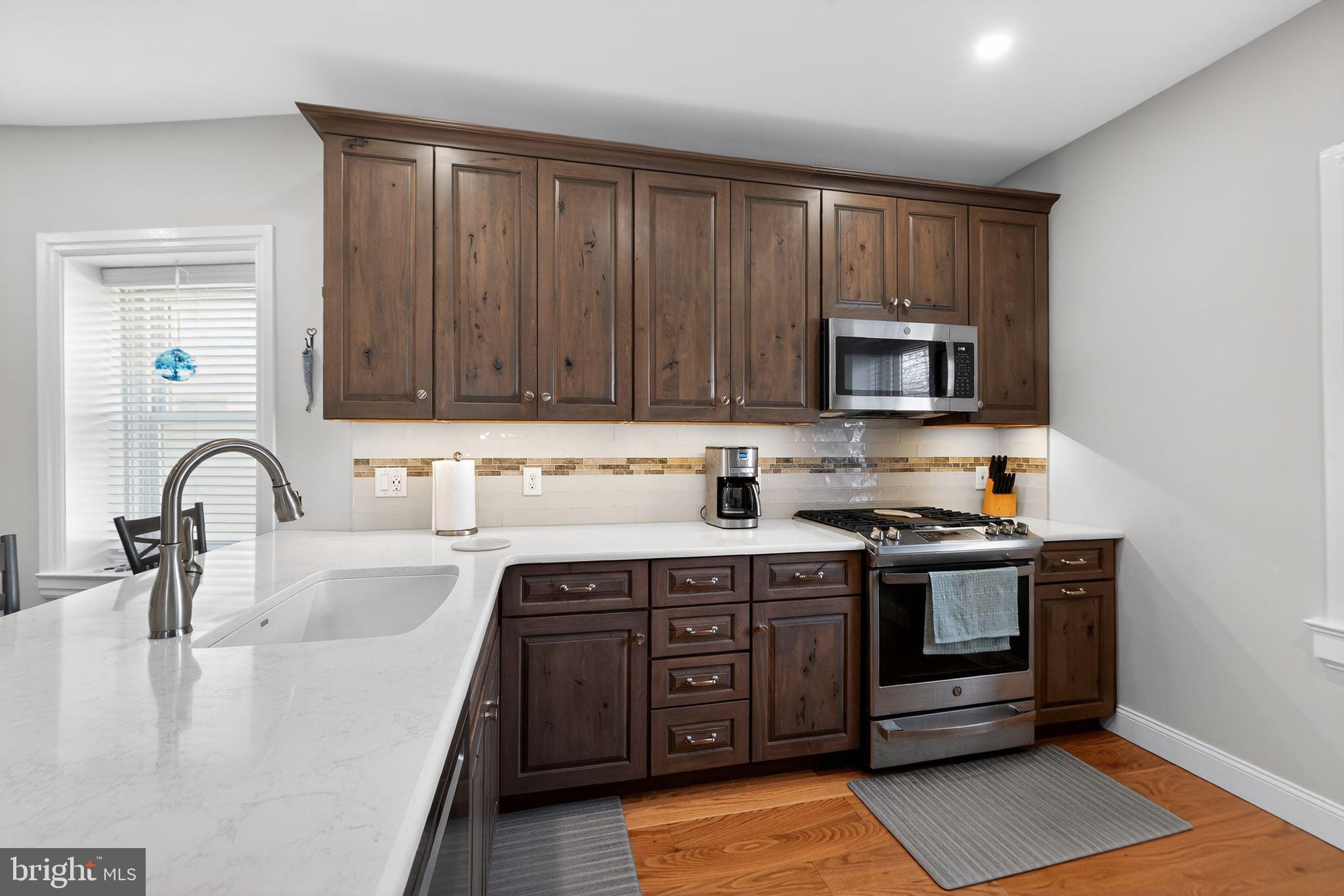 2143 Haig Avenue Morton, PA 19070 - Photo 14 of 29 a kitchen with stainless steel appliances granite countertop a sink stove and microwave