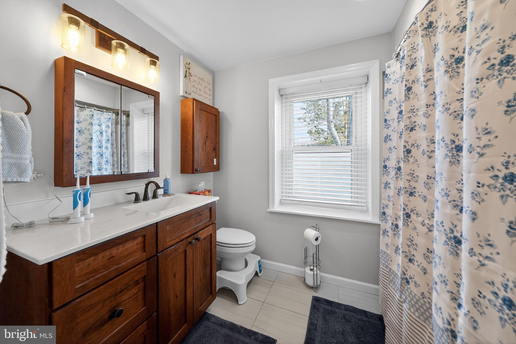 2143 Haig Avenue Morton, PA 19070 - Photo 24 of 29 a bathroom with a sink toilet a mirror and window