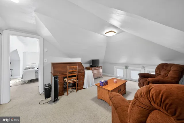 a bedroom with furniture and a lamp