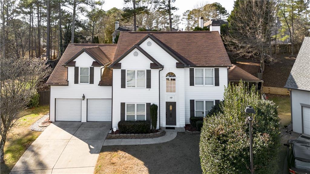 1004 Cavesson Terrace Lawrenceville, GA 30045 - Photo 1 of 48 a view of a white house with large windows and a small yard