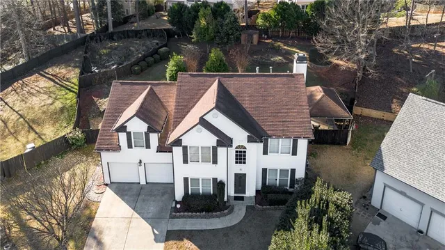 an aerial view of a house with a yard table and chairs