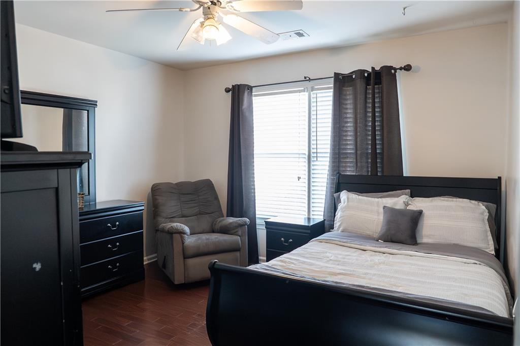 1004 Cavesson Terrace Lawrenceville, GA 30045 - Photo 24 of 48 a bedroom with a bed and wooden floor