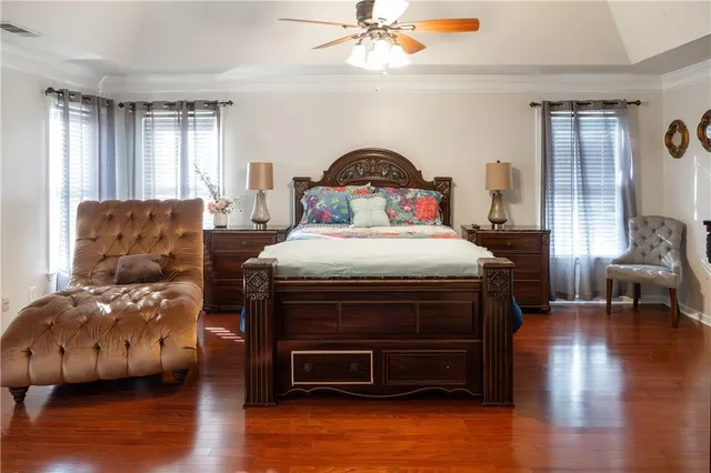 a bedroom with bed and wooden floor