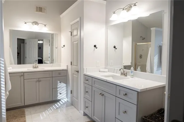 a bathroom with a sink double vanity and a mirror