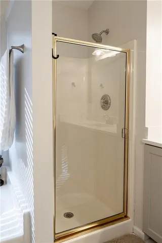 a bathroom with a glass shower door