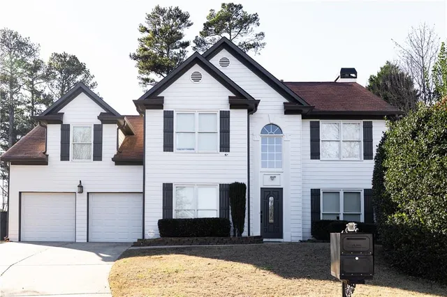 a front view of a house with a yard