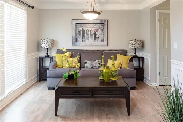 a living room with furniture and wooden floor