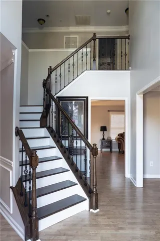 a view of entryway and hall with wooden floor