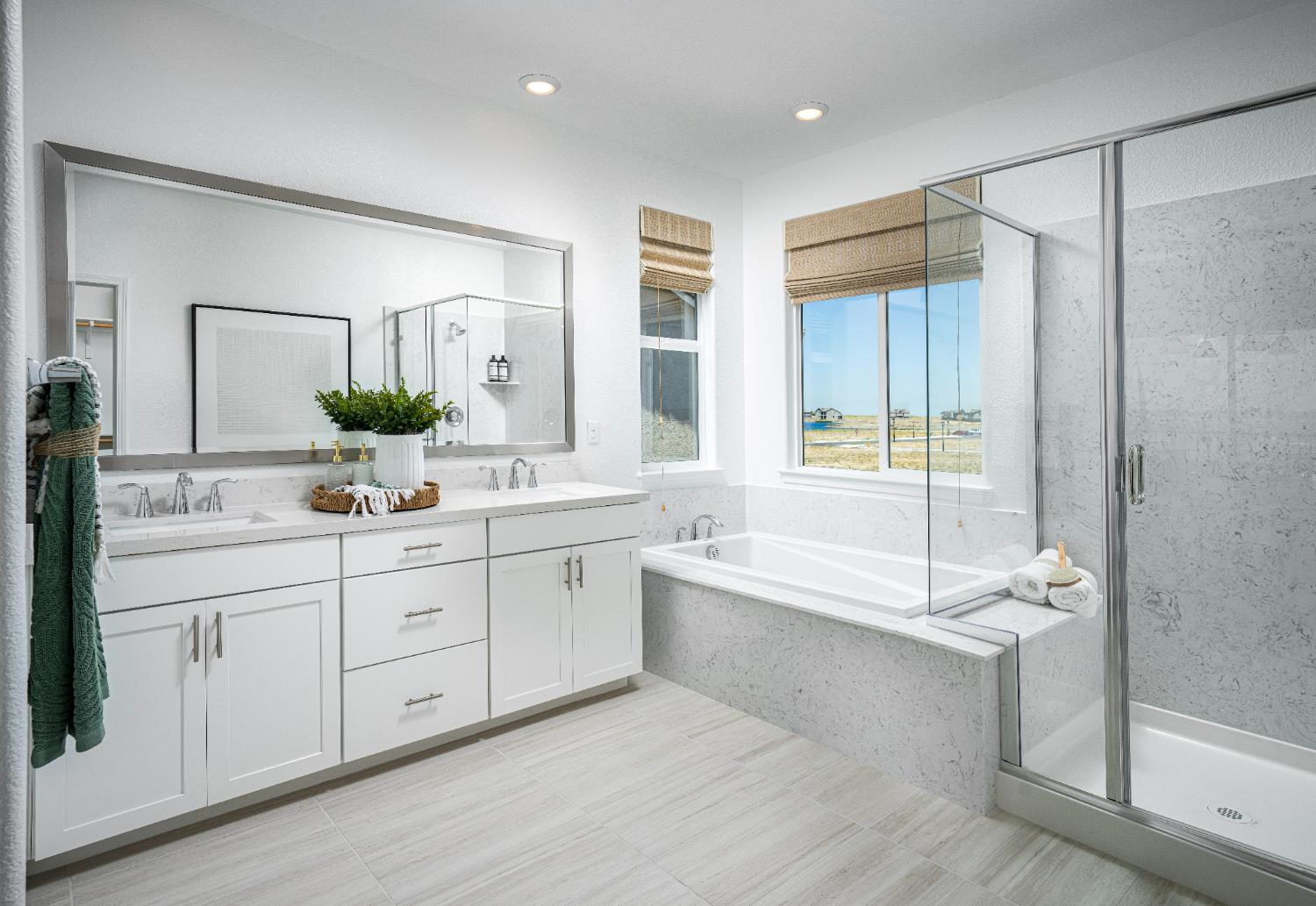 6708 Kaweah Lane Stockton, CA 95219 - Photo 11 of 21 a spacious bathroom with a double vanity sink a large mirror and a bathtub