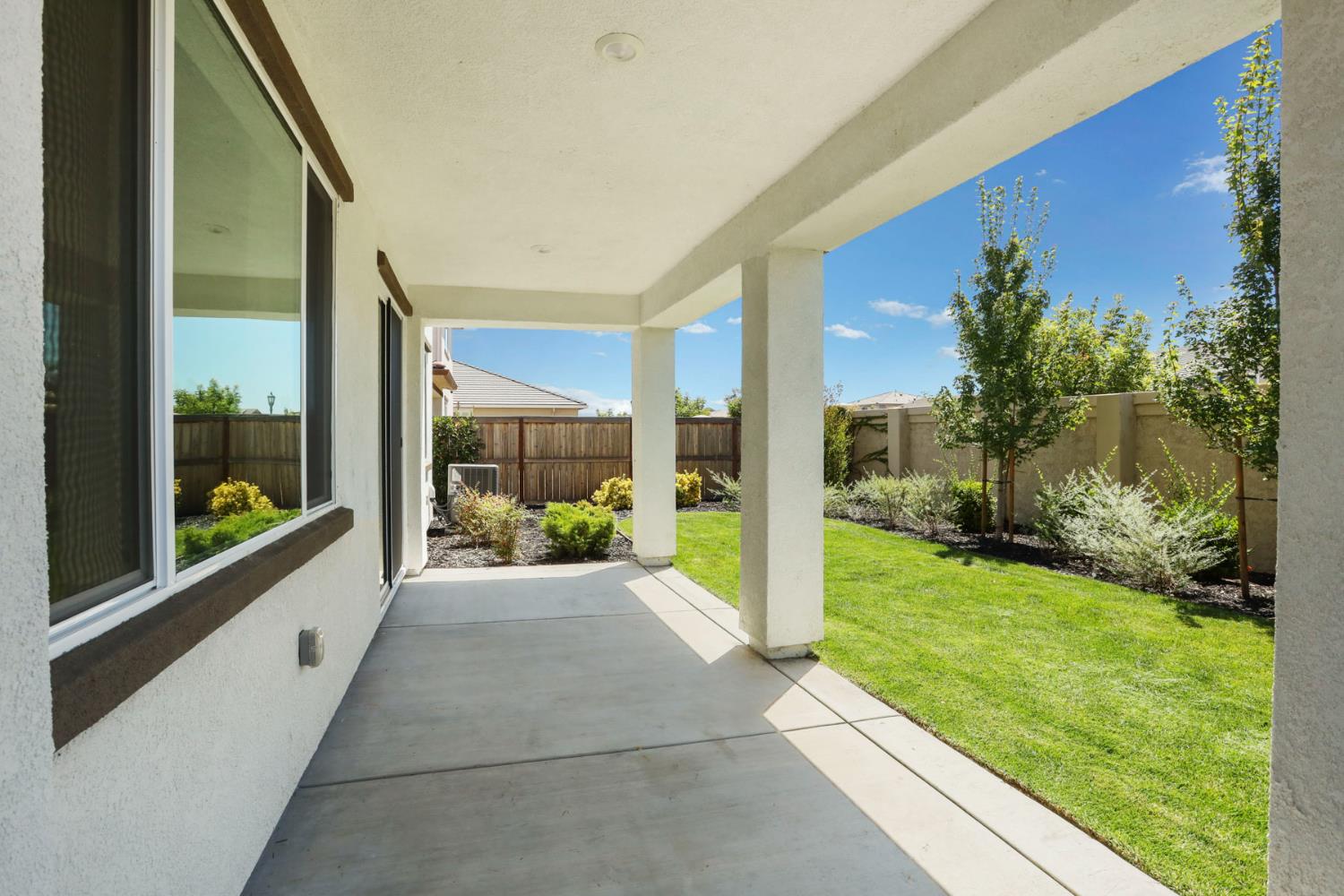 6708 Kaweah Lane Stockton, CA 95219 - Photo 19 of 21 a porch with a table and chairs next to yard