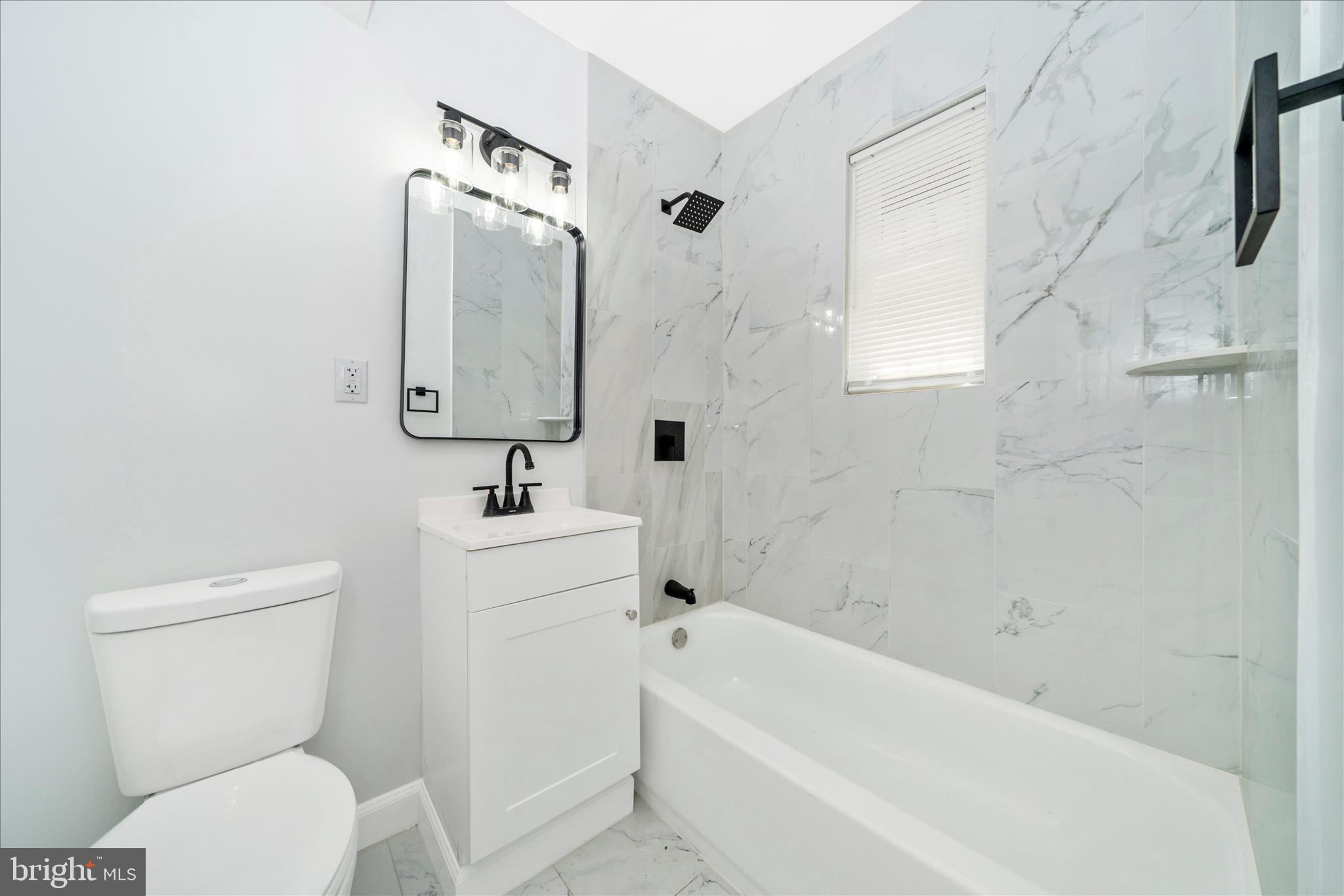 5027 Benning Road Southeast Washington, DC 20019 - Photo 29 of 57 a bathroom with a toilet sink shower and bathtub