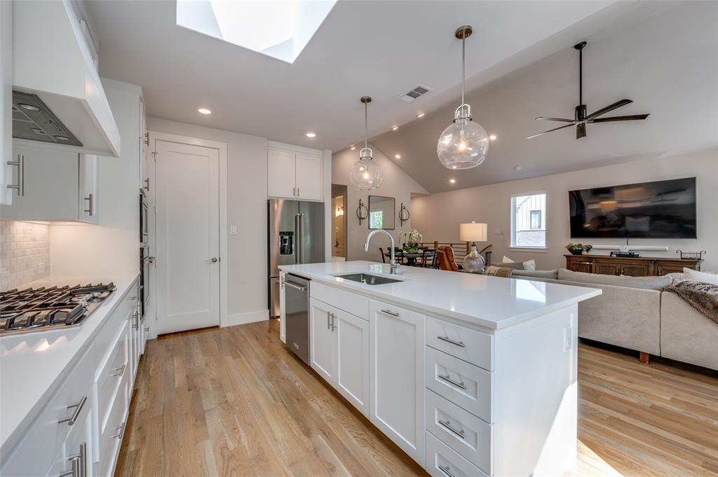 9142 Prado Lane Dallas, TX 75220 - Photo 12 of 21 a kitchen with white cabinets and stainless steel appliances