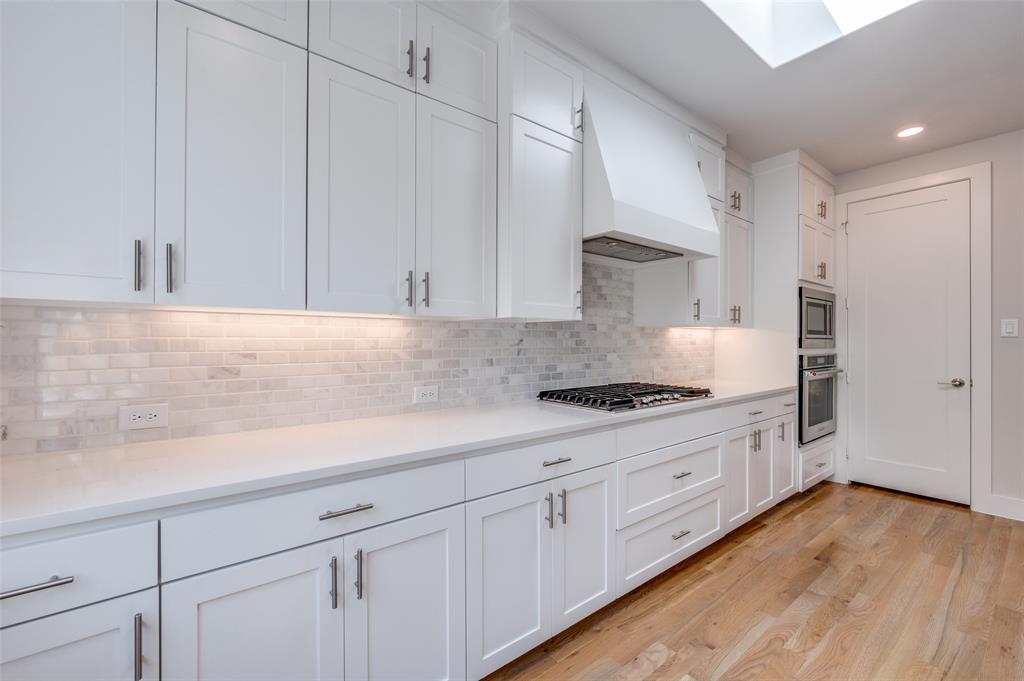 9142 Prado Lane Dallas, TX 75220 - Photo 13 of 21 a kitchen with granite countertop white cabinets and white appliances