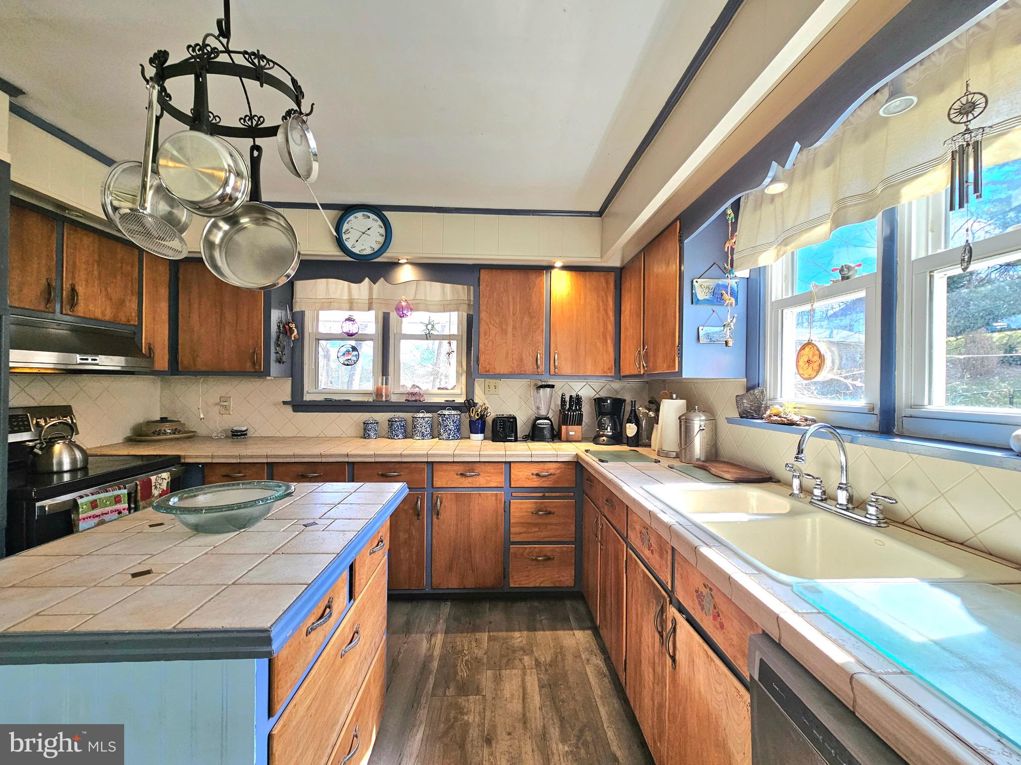 205 Valley View Road Hellertown, PA 18055 - Photo 13 of 27 a kitchen with stainless steel appliances granite countertop a sink a stove and a wooden floors