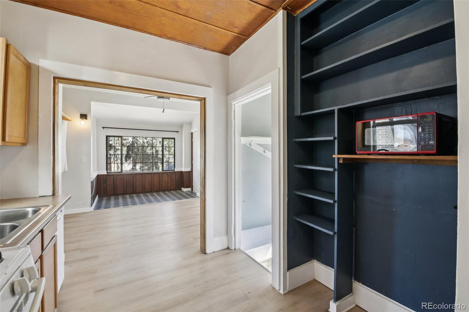 2715 Cook Street Denver, CO 80205 - Photo 11 of 30 a view of a livingroom with wooden floor and a ceiling fan