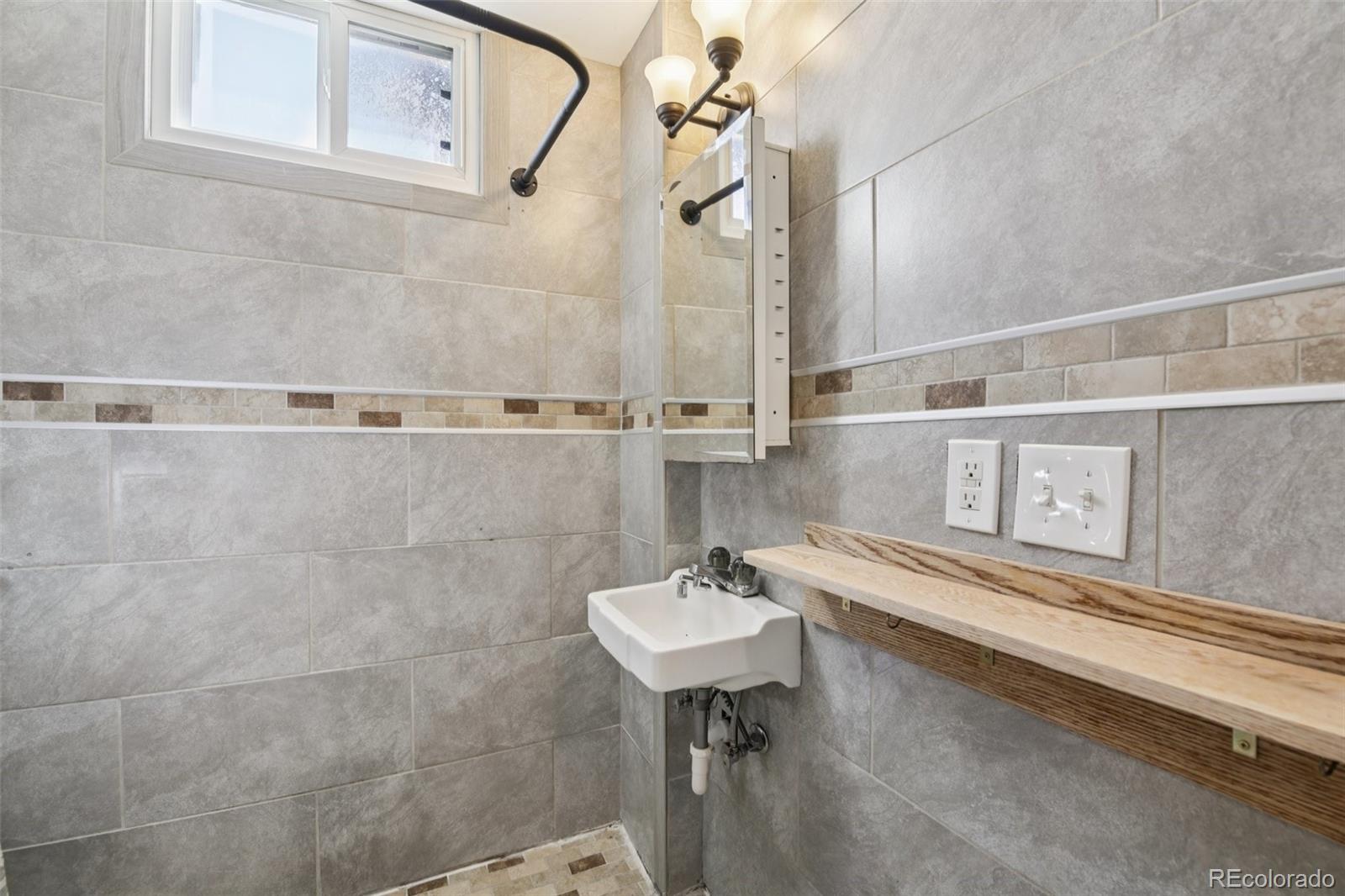 2715 Cook Street Denver, CO 80205 - Photo 12 of 30 a bathroom with a sink and a mirror