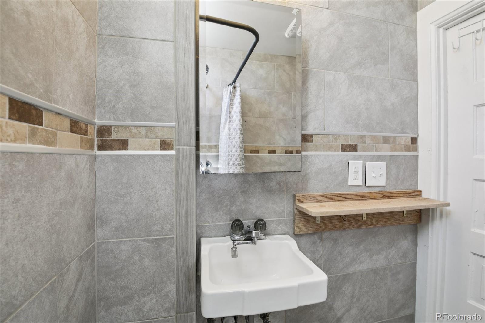 2715 Cook Street Denver, CO 80205 - Photo 13 of 30 a bathroom with a sink and a mirror