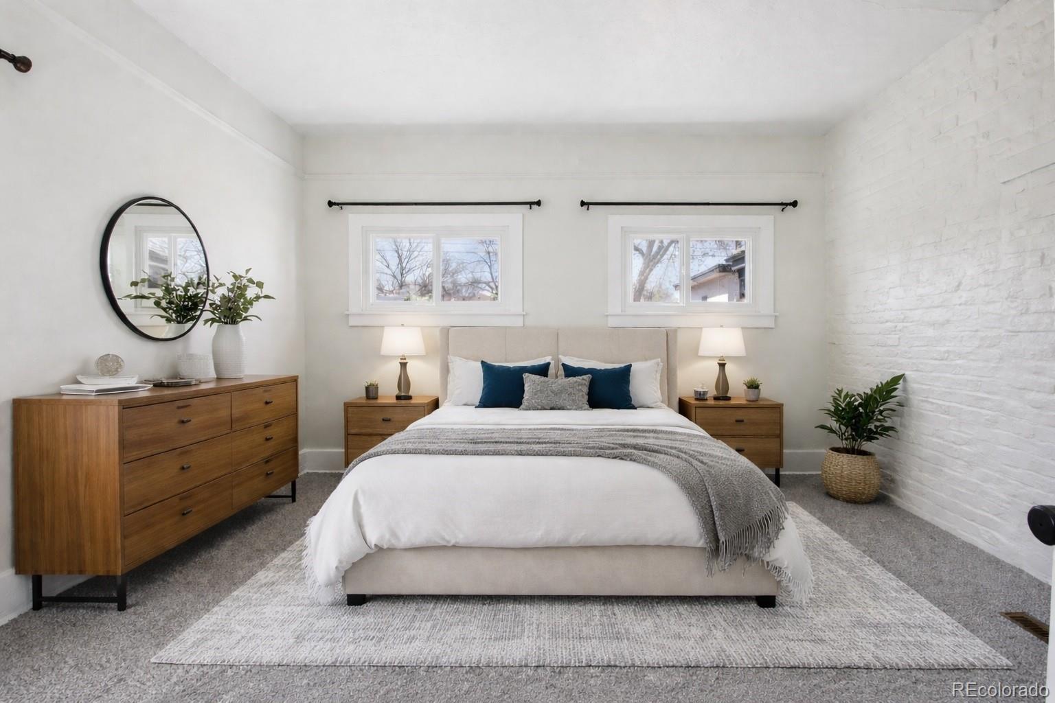 2715 Cook Street Denver, CO 80205 - Photo 14 of 30 a spacious bedroom with a bed and a table