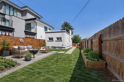 a view of a house with backyard and sitting area