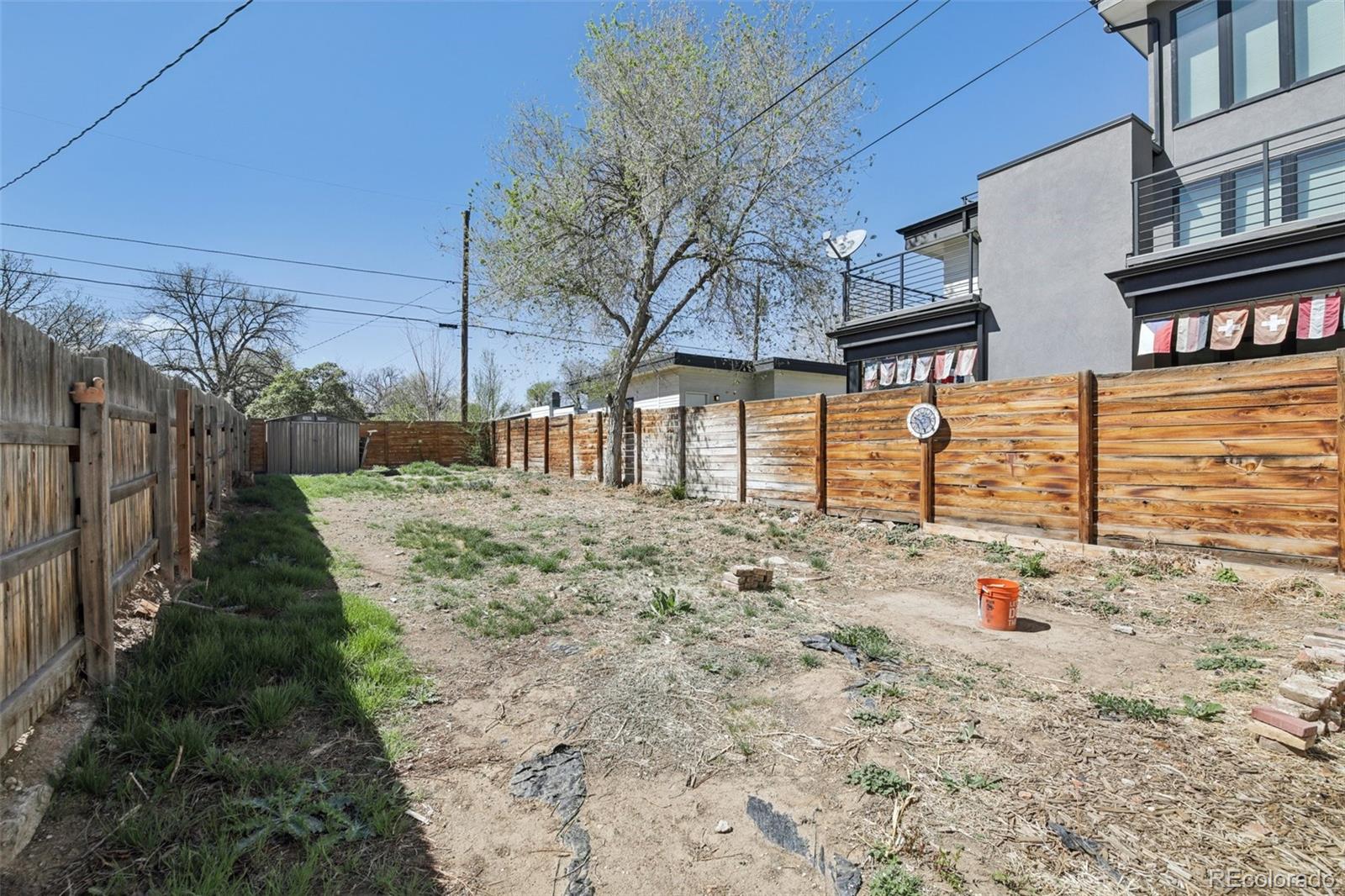2715 Cook Street Denver, CO 80205 - Photo 23 of 30 a backyard of a house with wooden fence
