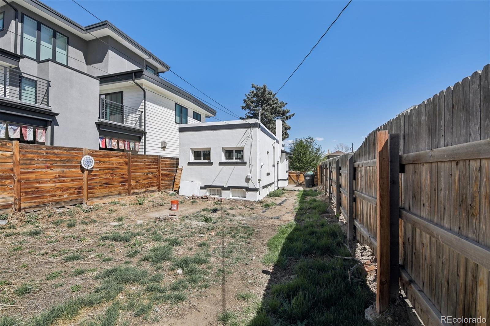 2715 Cook Street Denver, CO 80205 - Photo 25 of 30 a view of a yard with plants and wooden fence