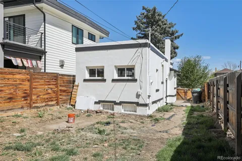 a view of a house with wooden fence