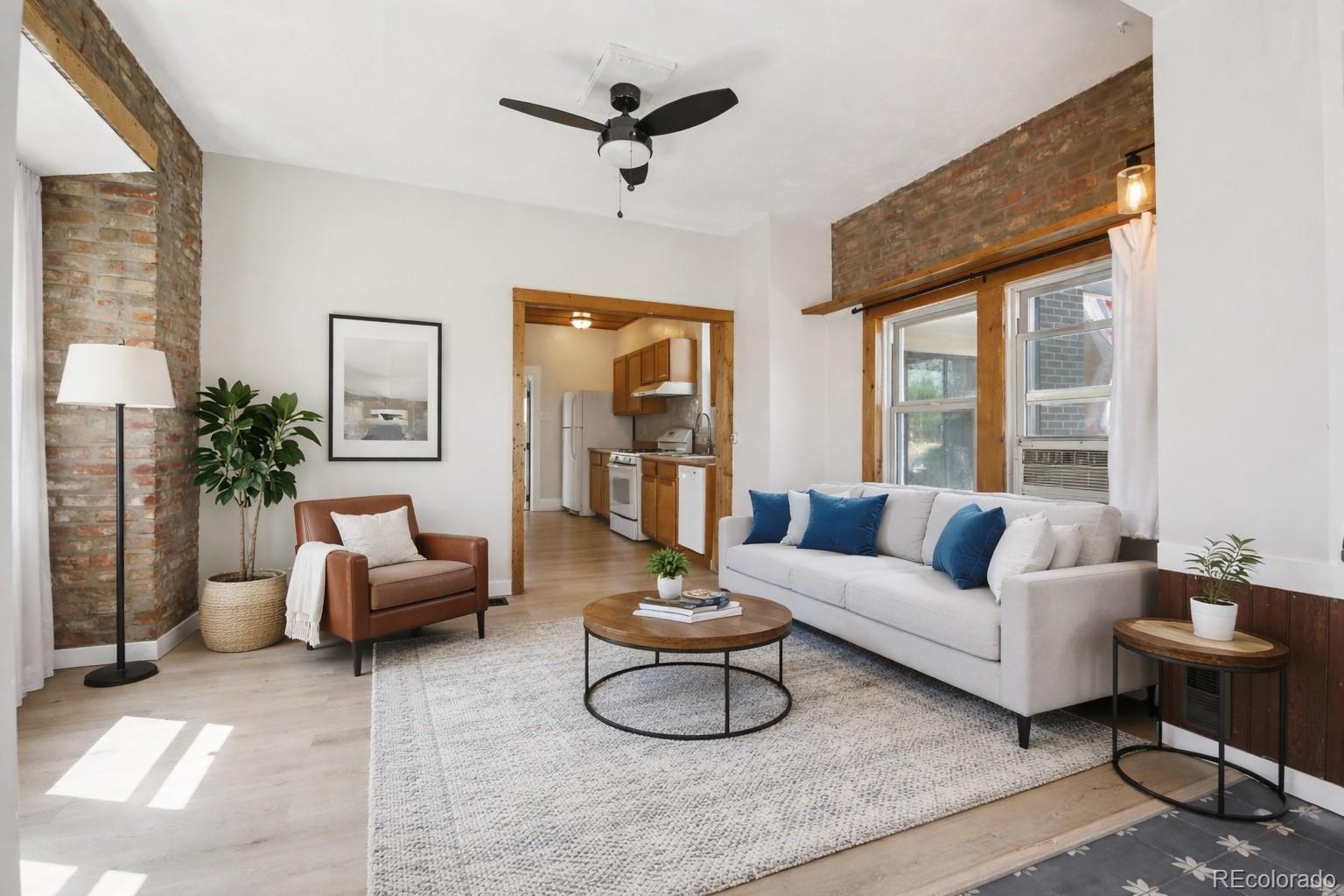 2715 Cook Street Denver, CO 80205 - Photo 4 of 30 a living room with furniture and a large window