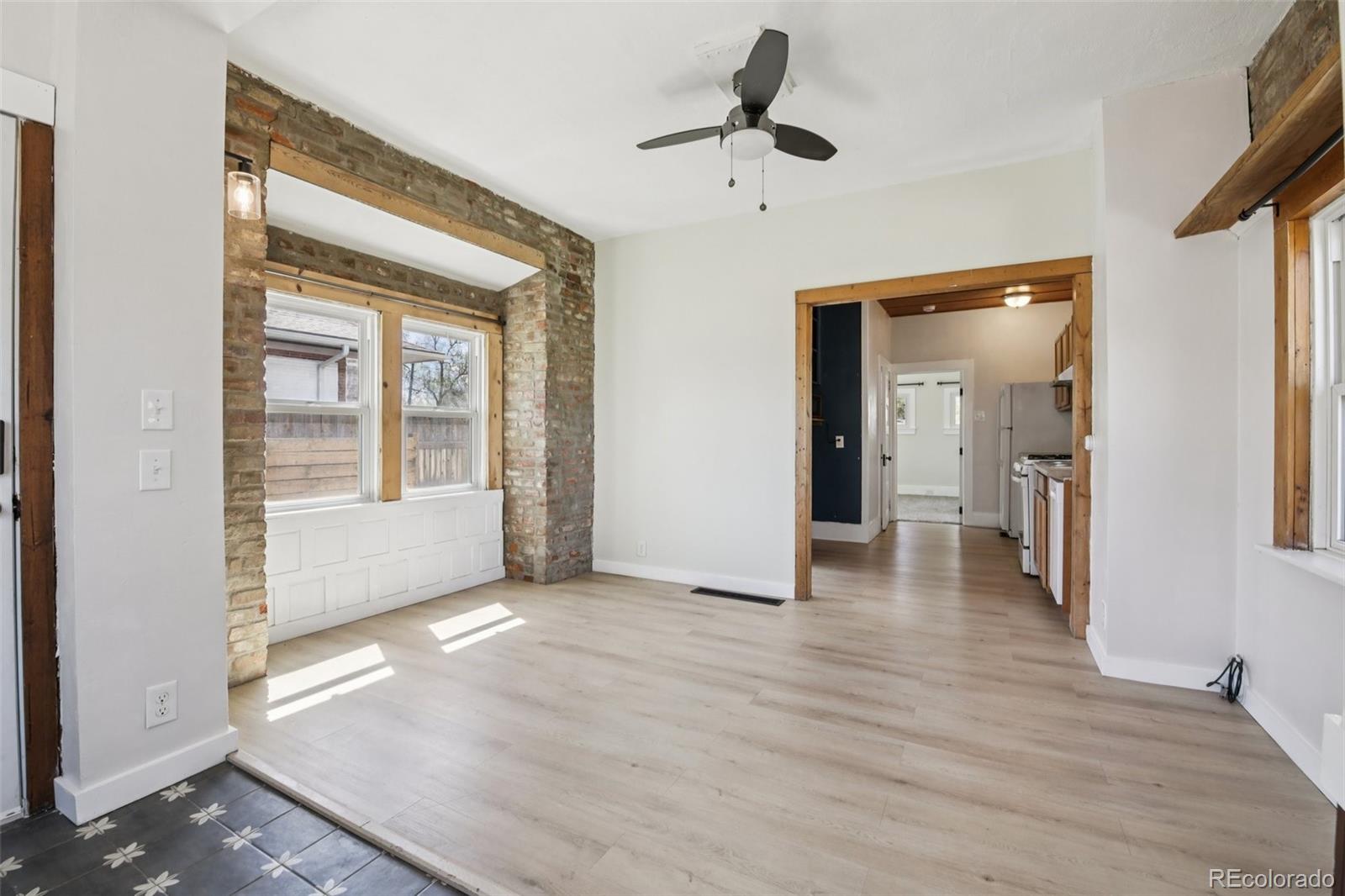 2715 Cook Street Denver, CO 80205 - Photo 6 of 30 a view of empty room with wooden floor and fan
