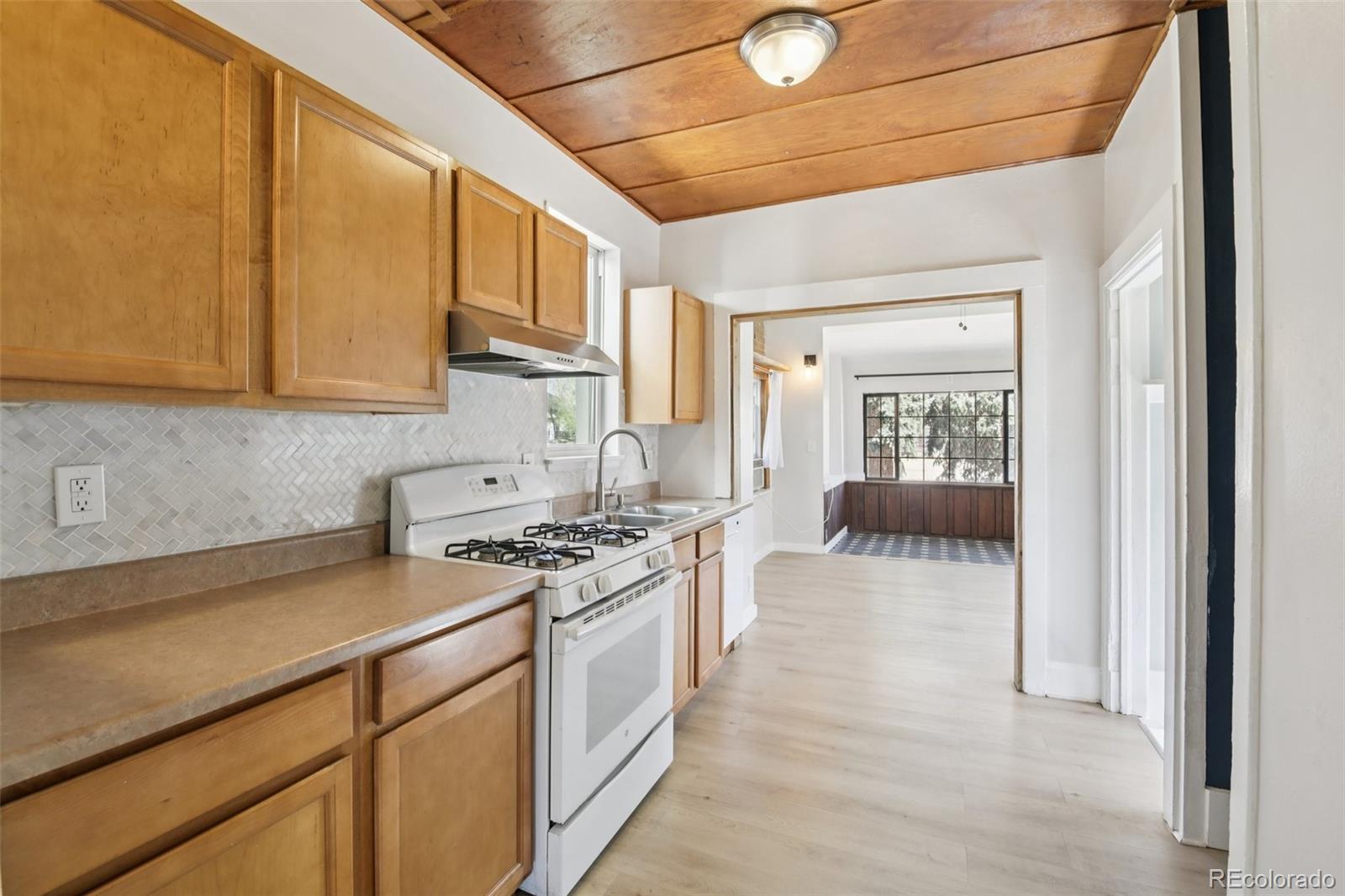 2715 Cook Street Denver, CO 80205 - Photo 10 of 30 a kitchen with stainless steel appliances granite countertop a stove and a sink