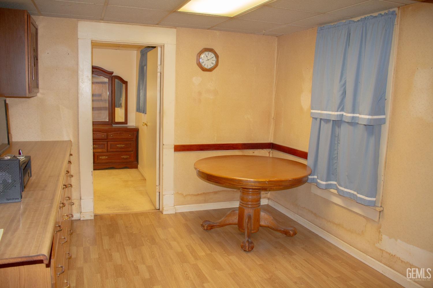 Undisclosed Address Bakersfield, CA 93307 - Photo 13 of 29 a view of a livingroom with furniture and hardwood floor