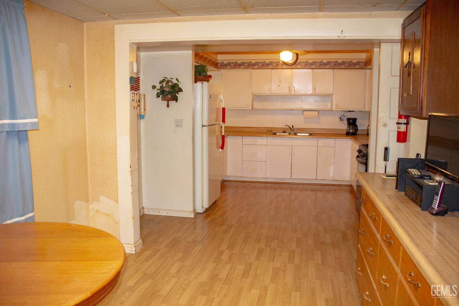 Undisclosed Address Bakersfield, CA 93307 - Photo 16 of 29 a kitchen with a refrigerator and a stove